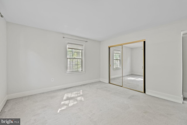2418 Forest Glen Rd, Silver Spring, MD 20910 - unfurnished bedroom featuring baseboards, multiple windows, carpet, and a closet