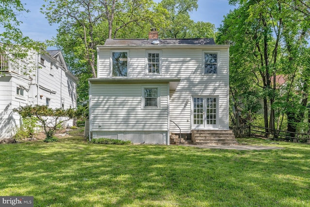2418 Forest Glen Rd, Silver Spring, MD 20910 - rear view of house featuring a lawn, fence, a chimney, and entry steps