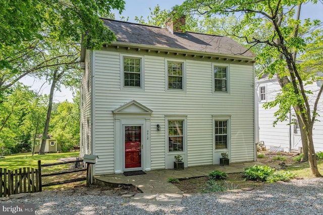2418 Forest Glen Rd, Silver Spring, MD 20910 - view of front of house with fence, a chimney, and a shingled roof