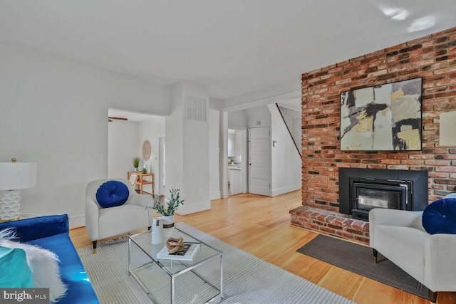 2418 Forest Glen Rd, Silver Spring, MD 20910 - living area featuring visible vents, baseboards, wood finished floors, and a fireplace