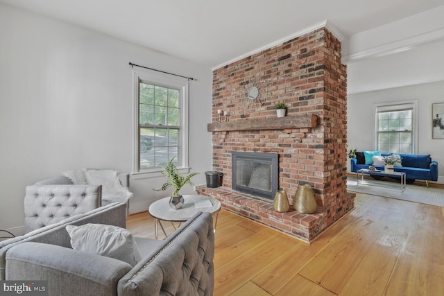 2418 Forest Glen Rd, Silver Spring, MD 20910 - living room featuring a brick fireplace, baseboards, a healthy amount of sunlight, and wood finished floors