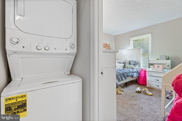 laundry area with carpet floors, laundry area, and stacked washer / dryer