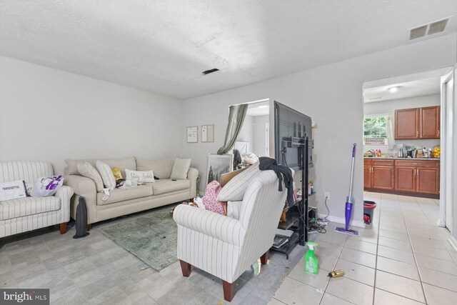 living room with a textured ceiling and visible vents