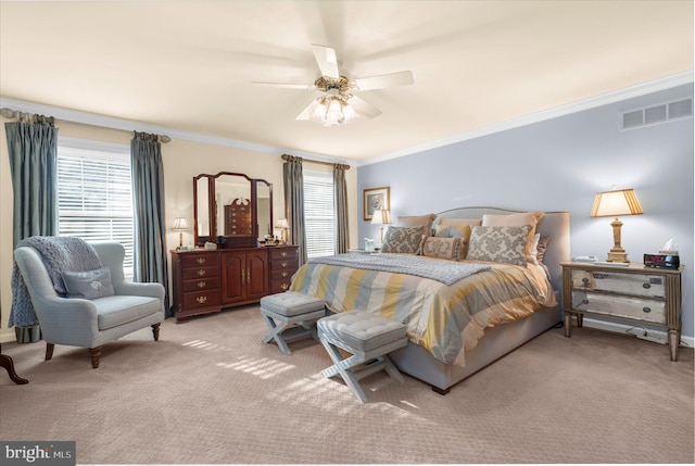 bedroom featuring light colored carpet, visible vents, and multiple windows