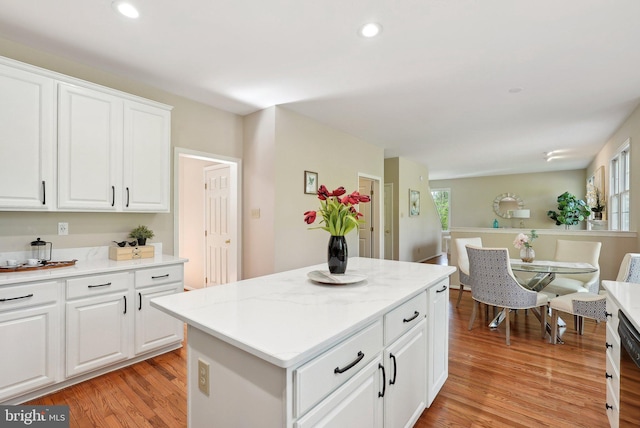 kitchen featuring recessed lighting, light wood-style floors, a kitchen island, and plenty of natural light