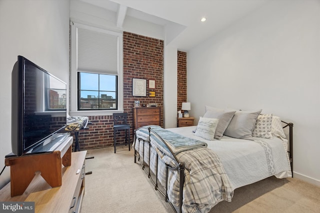bedroom featuring brick wall and carpet