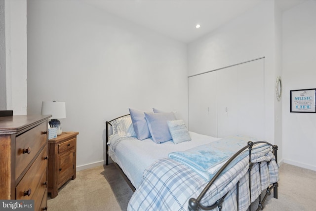 bedroom with light colored carpet, baseboards, a closet, and recessed lighting