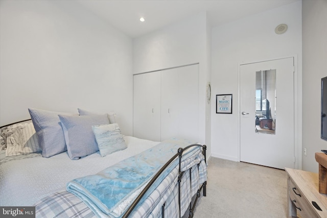 bedroom featuring light colored carpet, recessed lighting, a closet, and baseboards