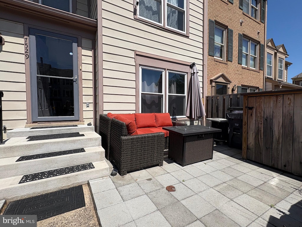 view of patio with fence, entry steps, and outdoor lounge area