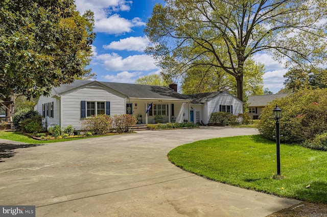 2231 Whays Creek Rd, Reedville, VA 22539 - ranch-style house featuring a front lawn, covered porch, curved driveway, and a chimney