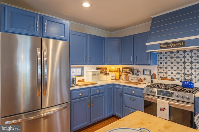 2231 Whays Creek Rd, Reedville, VA 22539 - kitchen with crown molding, custom range hood, stainless steel appliances, blue cabinetry, and backsplash