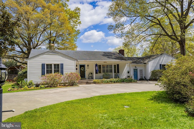 2231 Whays Creek Rd, Reedville, VA 22539 - ranch-style house featuring a porch, a front lawn, a shingled roof, driveway, and a chimney