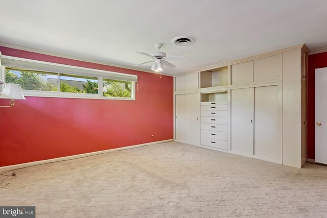 unfurnished bedroom with crown molding, baseboards, visible vents, and a closet