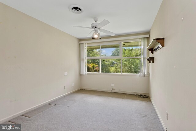 unfurnished room with baseboards, carpet flooring, ceiling fan, and visible vents