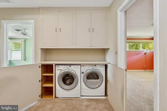 washroom with light carpet, a ceiling fan, cabinet space, and washing machine and clothes dryer