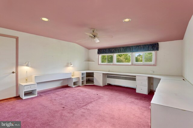 unfurnished office featuring radiator heating unit, carpet, a ceiling fan, and lofted ceiling