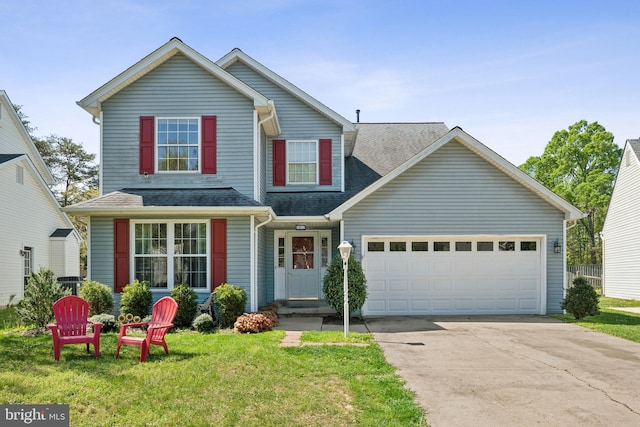 traditional-style home featuring a front lawn, driveway, a garage, and roof with shingles