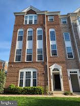 multi unit property featuring brick siding and an attached garage