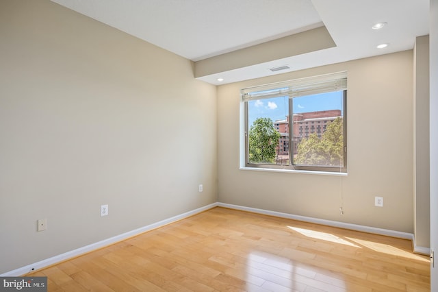empty room with baseboards, light wood-style floors, and recessed lighting