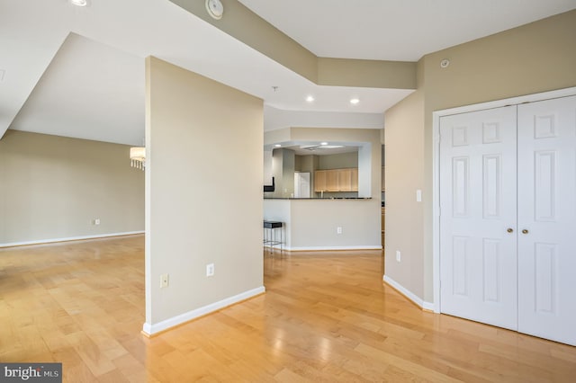 unfurnished living room with light wood-style floors, baseboards, and recessed lighting