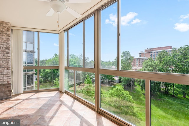 unfurnished sunroom featuring brick wall
