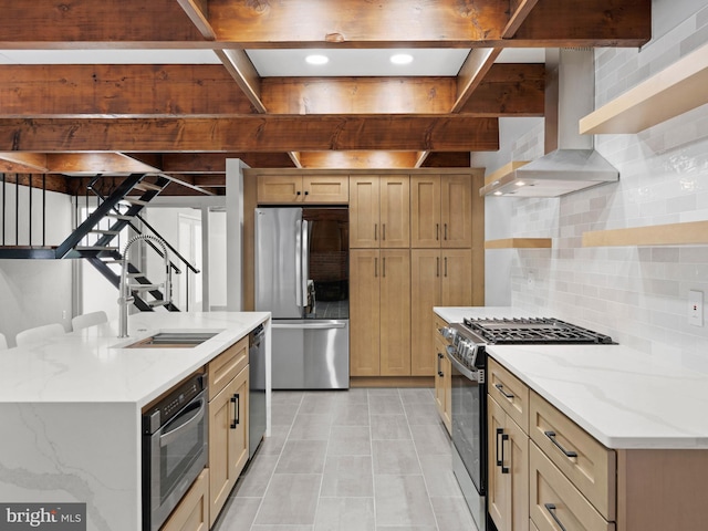 kitchen featuring open shelves, a sink, wall chimney exhaust hood, stainless steel appliances, and tasteful backsplash