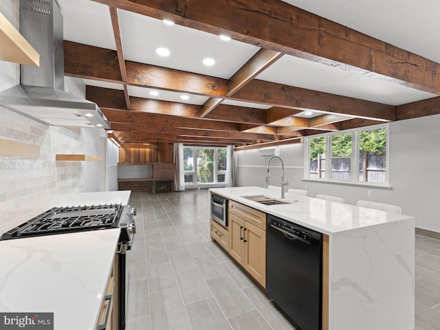 kitchen featuring a sink, dishwasher, stainless steel range with gas stovetop, wall chimney exhaust hood, and decorative backsplash