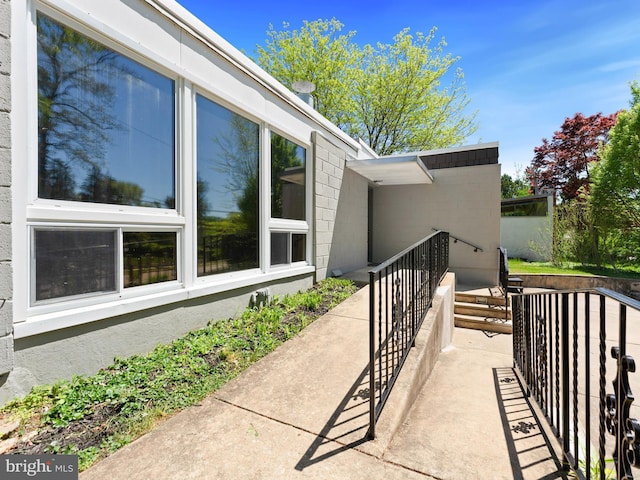 view of side of home featuring concrete block siding