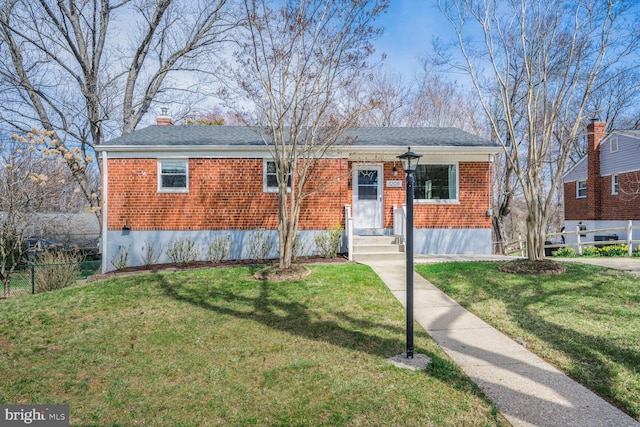 12011 Ashley Dr, Rockville, MD 20852 - view of front of property with fence, a chimney, a front lawn, and brick siding