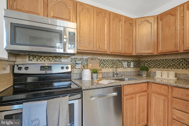 12011 Ashley Dr, Rockville, MD 20852 - kitchen with light stone counters, a sink, appliances with stainless steel finishes, and backsplash
