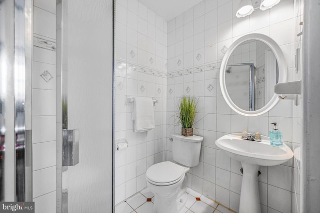 12011 Ashley Dr, Rockville, MD 20852 - bathroom featuring tile patterned floors, toilet, and tile walls