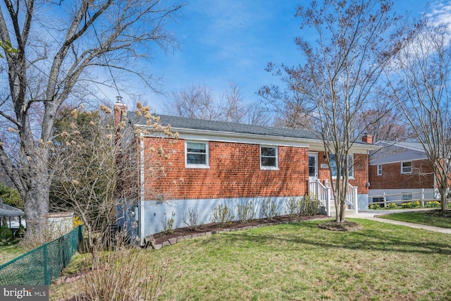12011 Ashley Dr, Rockville, MD 20852 - view of property exterior featuring fence, a chimney, and brick siding