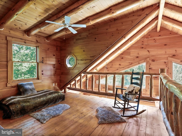 sitting room with a ceiling fan, lofted ceiling with beams, a wealth of natural light, and wooden ceiling