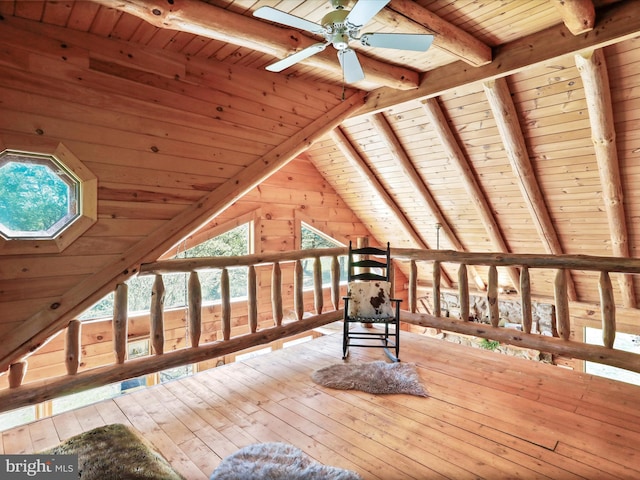 bonus room featuring a ceiling fan, vaulted ceiling with beams, wood ceiling, and hardwood / wood-style floors