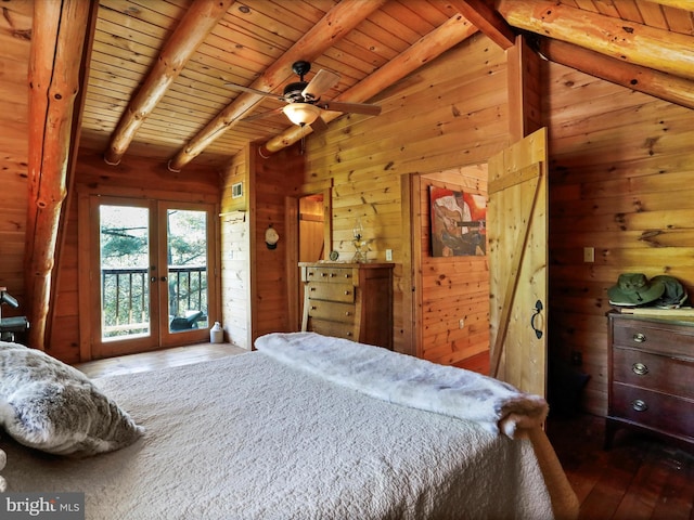bedroom with french doors, wooden walls, hardwood / wood-style floors, and access to exterior