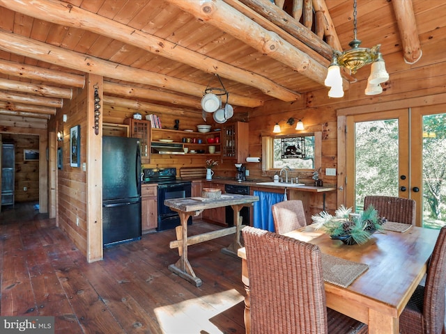 dining room featuring wood walls, beamed ceiling, dark wood-type flooring, wooden ceiling, and french doors