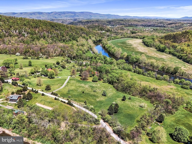 aerial view with a water and mountain view and a forest view