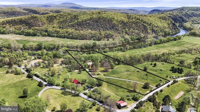 drone / aerial view featuring a water and mountain view