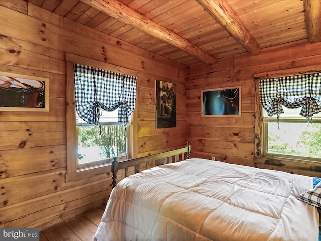 bedroom featuring beamed ceiling, wood walls, multiple windows, and wood ceiling