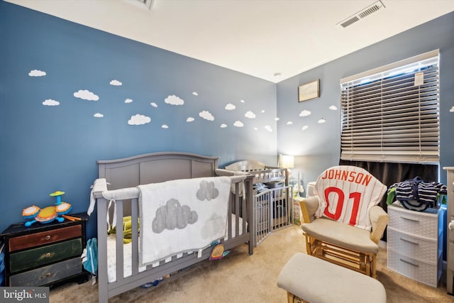 carpeted bedroom with visible vents and a nursery area