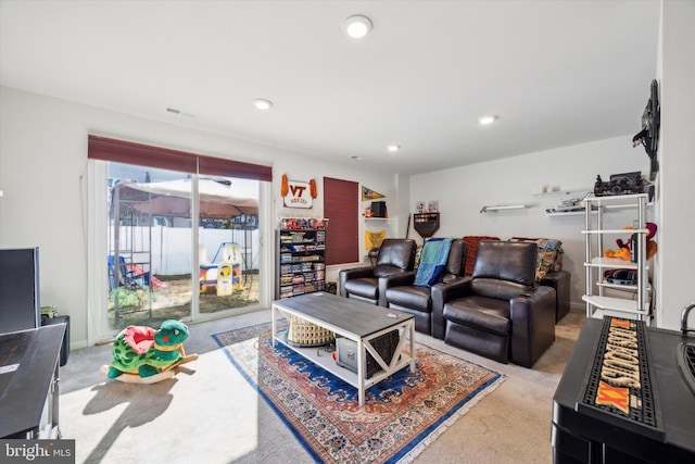 living room featuring visible vents, recessed lighting, and light colored carpet