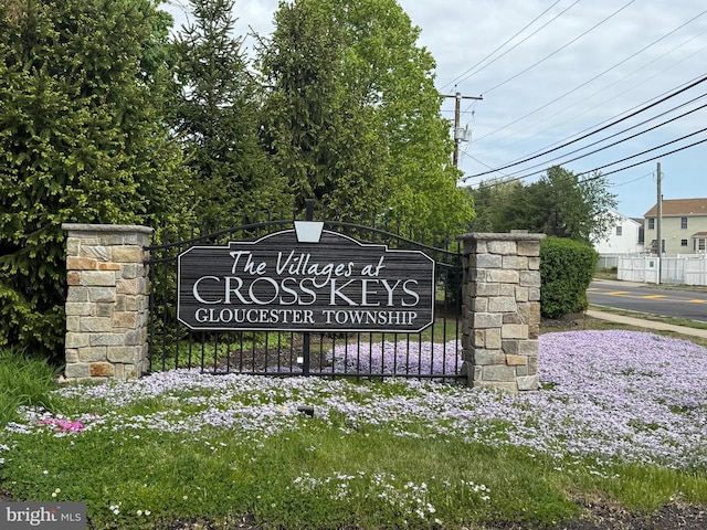 community / neighborhood sign with fence