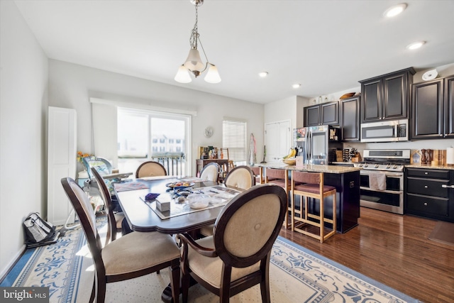 dining area with recessed lighting and dark wood-type flooring