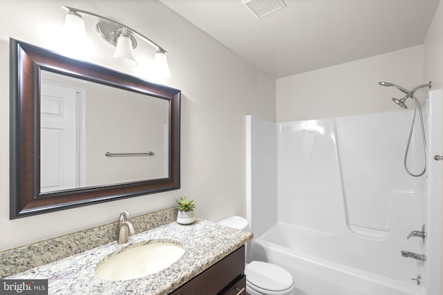 bathroom featuring toilet, vanity, and washtub / shower combination