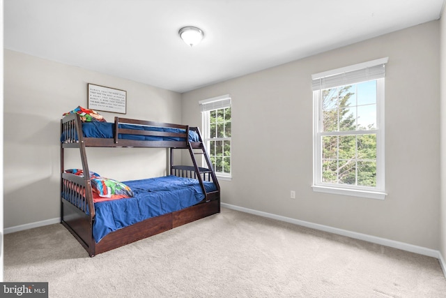 bedroom with carpet and baseboards