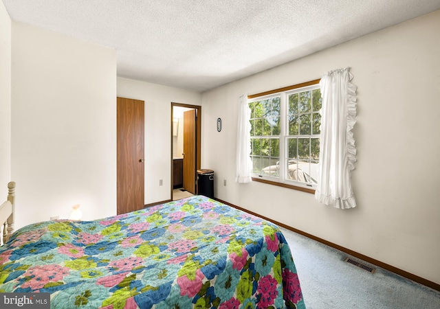 carpeted bedroom featuring baseboards, a textured ceiling, and visible vents