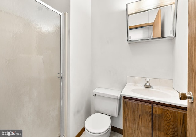 full bathroom featuring toilet, a shower stall, and vanity