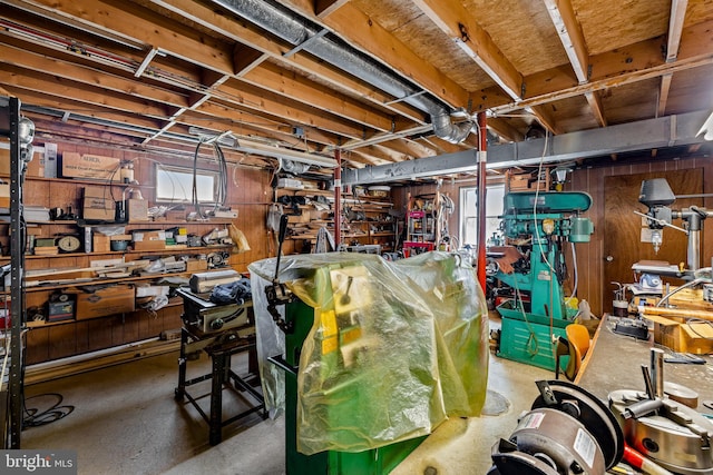 below grade area with wood walls and a workshop area