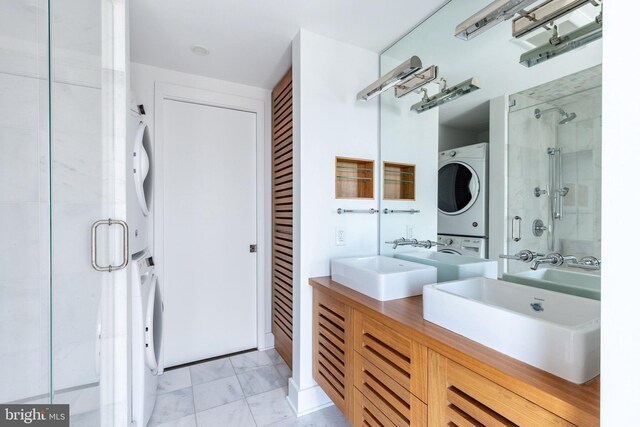 1830 Rittenhouse Sq Unit 17B, Philadelphia, PA 19103 - bathroom featuring a closet, a stall shower, stacked washer and dryer, and a sink