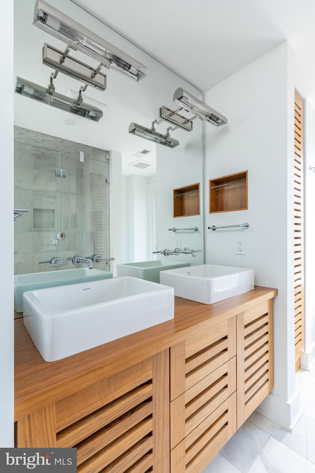 1830 Rittenhouse Sq Unit 17B, Philadelphia, PA 19103 - full bath featuring a sink, a stall shower, double vanity, and marble finish floor